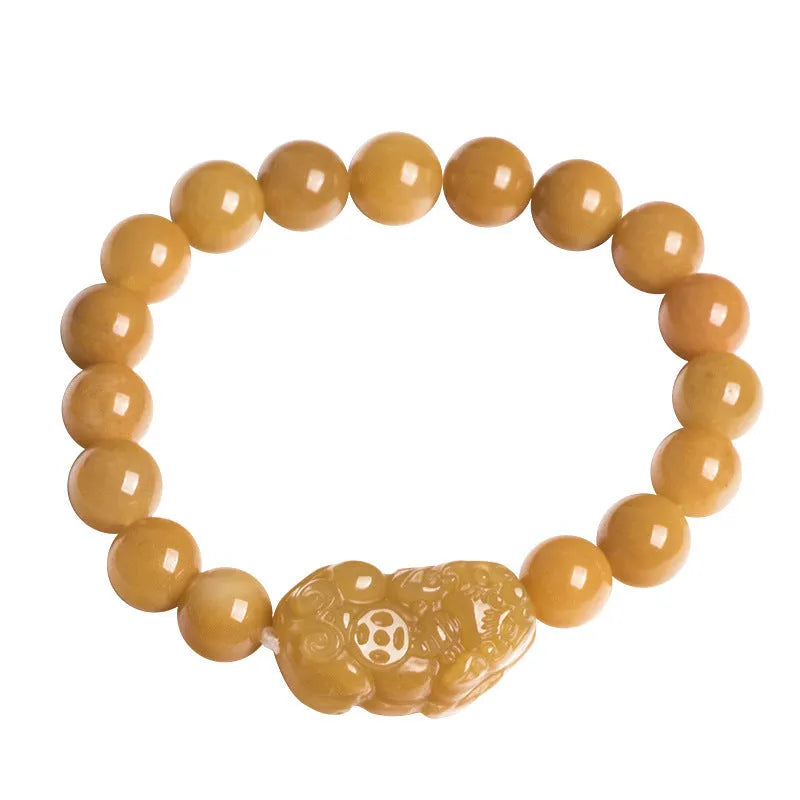 Golden thread jade bracelet with carved money motif showing detailed surface texture and jade beads