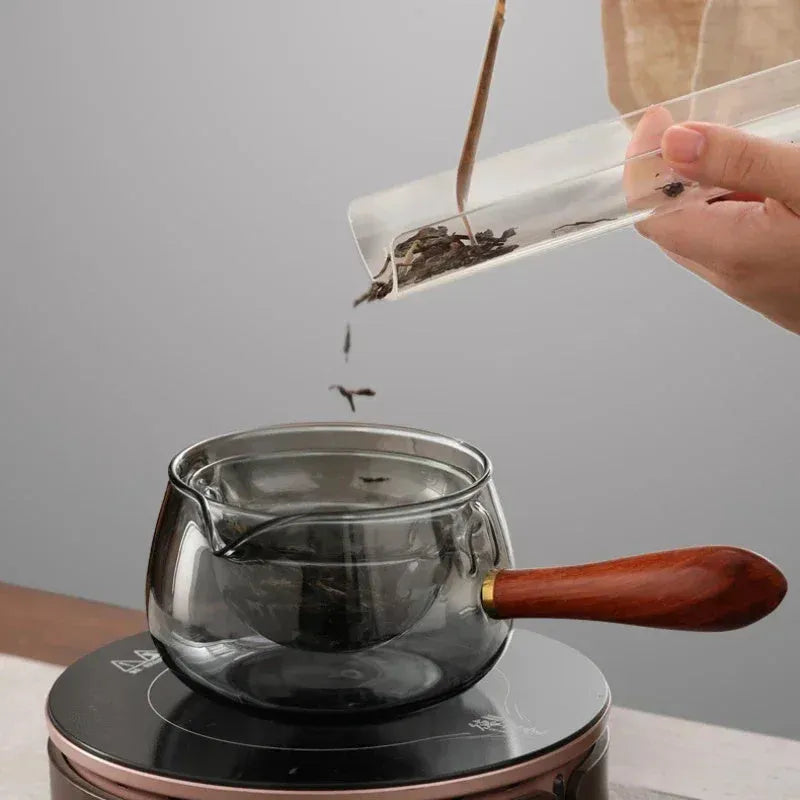 Transparent borosilicate glass teapot with wooden handle and rotation mechanism