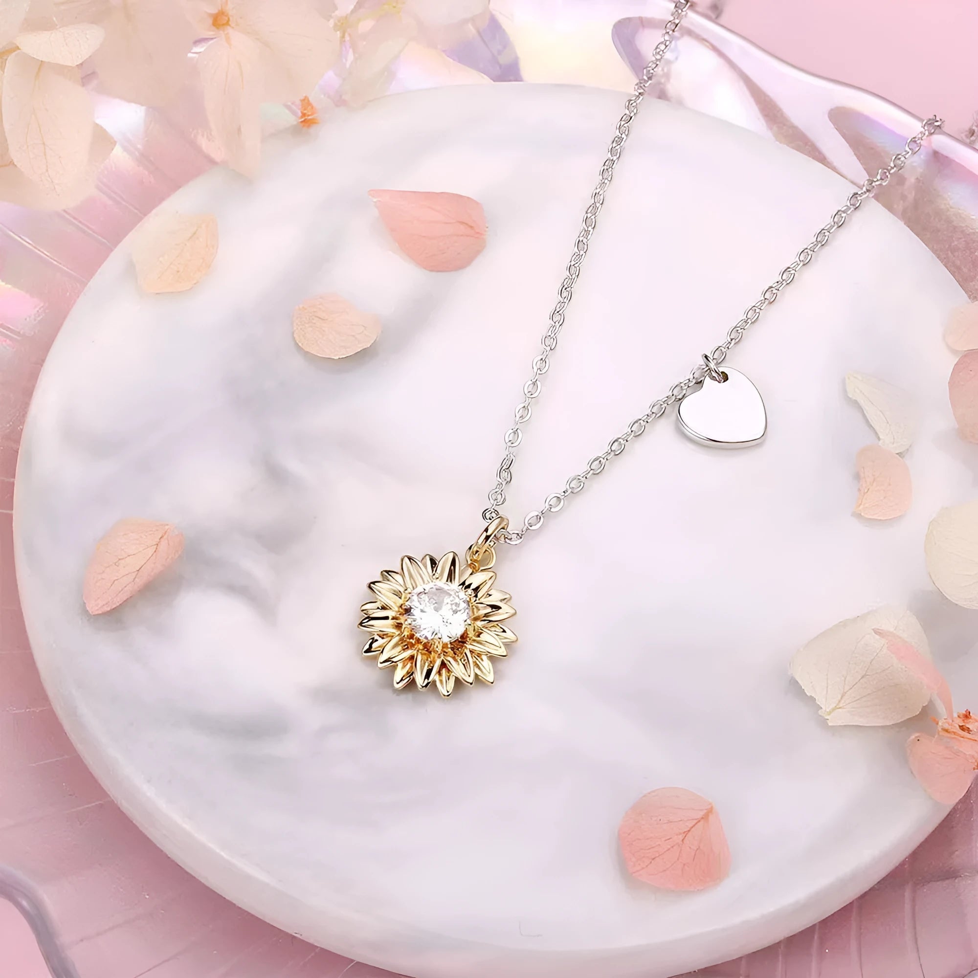 Close-up of a sterling silver sunflower necklace with geometric daisy pendant on an adjustable cross chain.