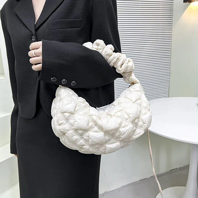 Women's solid colour nylon messenger bag with long shoulder strap shown in beige.