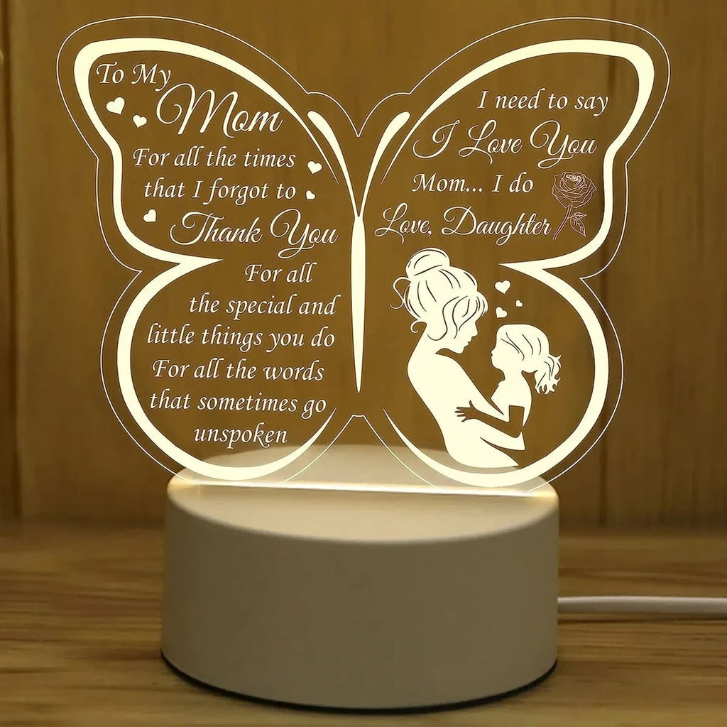 White heart-shaped acrylic table lamp with touch control on a wooden surface.