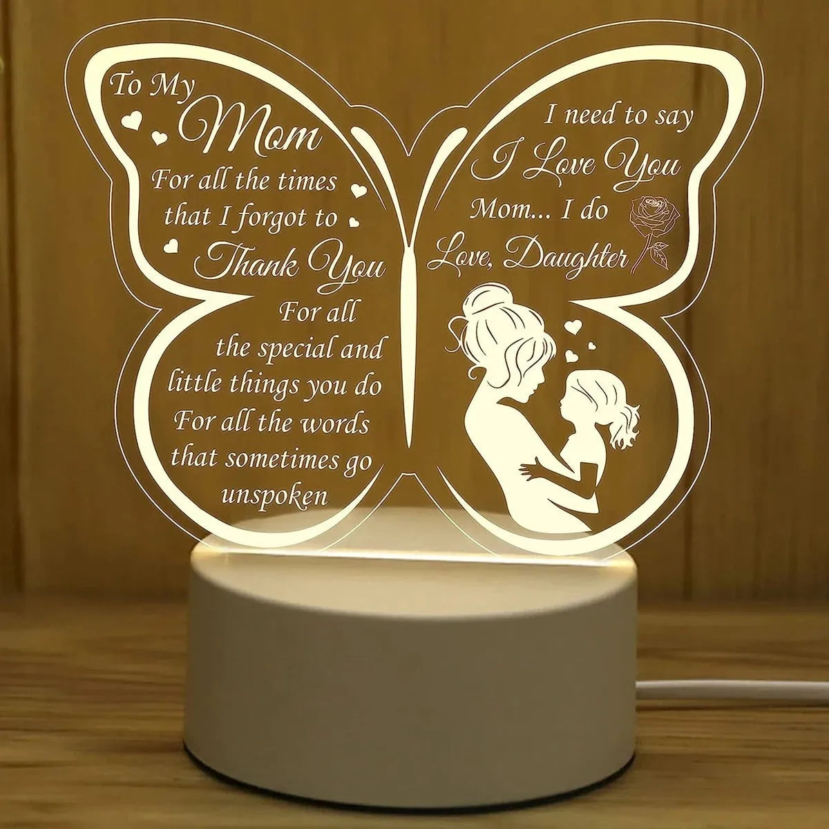 White heart-shaped acrylic table lamp with touch control on a wooden surface.