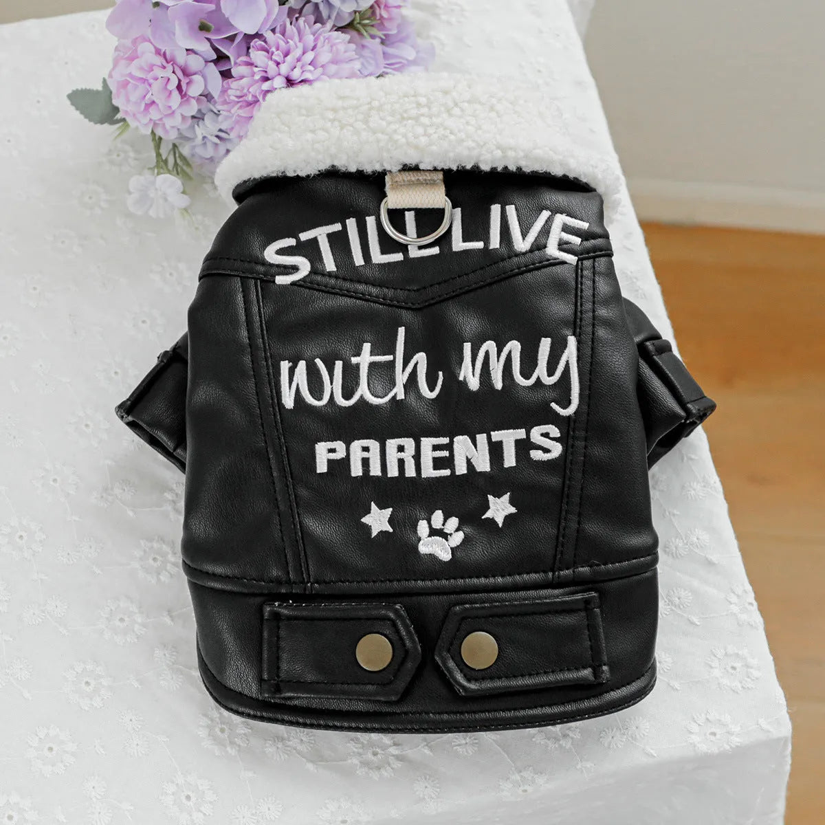 Dog wearing fleece lined padded coat in black colour with visible fleece lining at neck