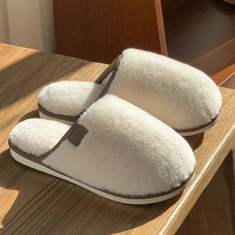 Pair of solid colour plush PVC winter slippers with non-slip soles for home use.
