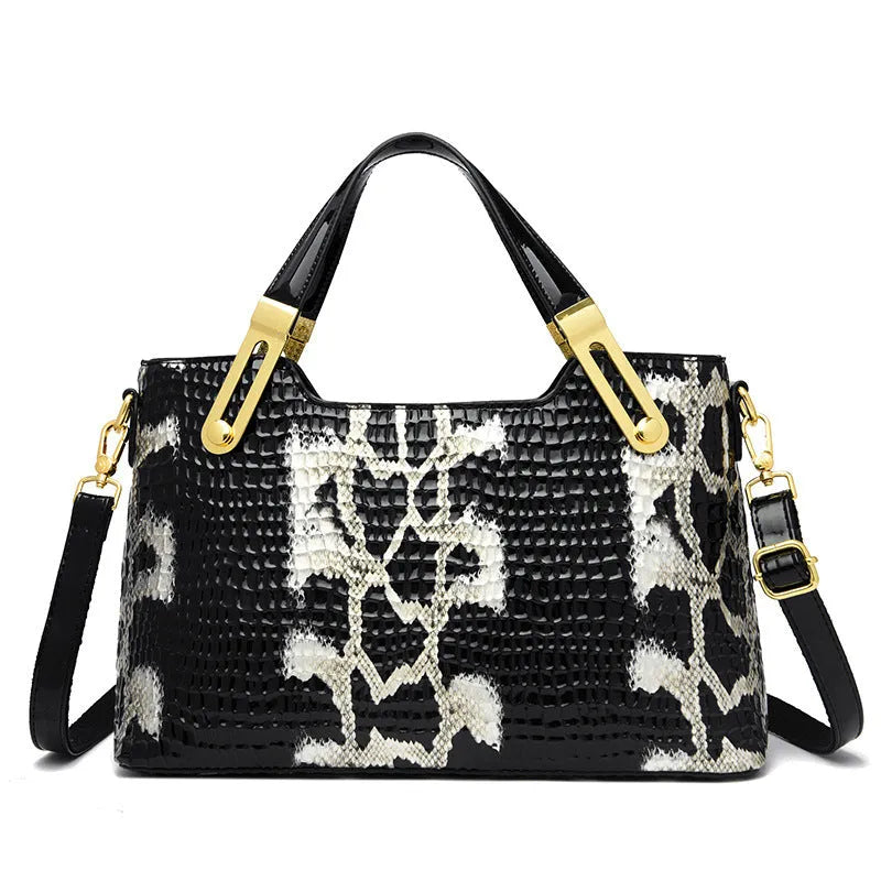 Black retro style shoulder messenger bag with chain detailing and horizontal square silhouette
