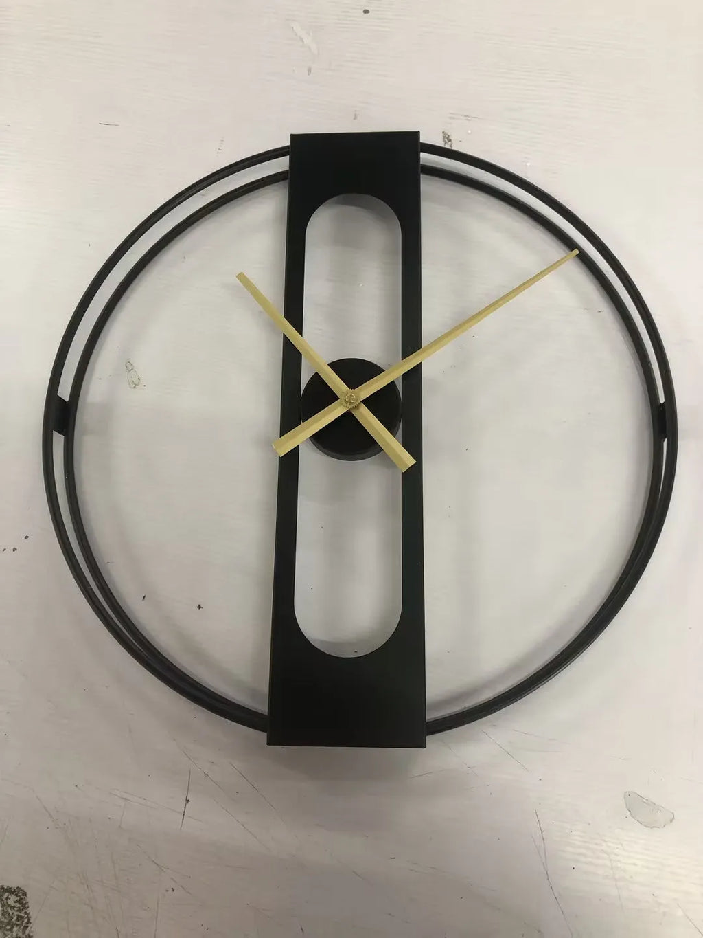 50cm round metal wall clock in black or gold finish on a wall