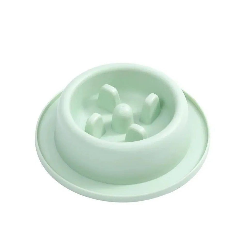 Blue pet slow feeder bowl with maze pattern and non-slip base on a kitchen floor