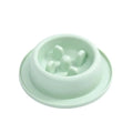 Blue pet slow feeder bowl with maze pattern and non-slip base on a kitchen floor