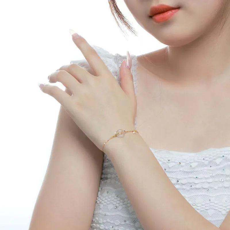 Women's silver bracelet with white chalcedony peace buckle charm and starry sky design