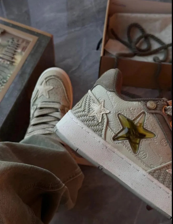 Green low-top casual shoes with star pattern and lace-up closure on a rubber sole.