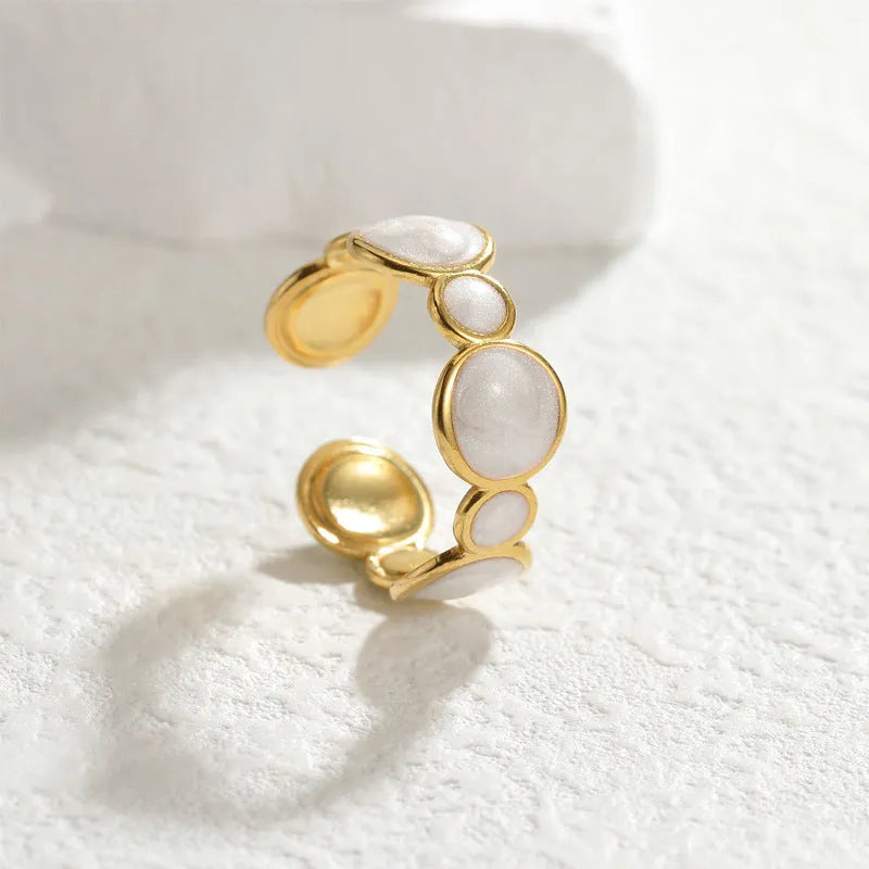A geometric-shaped stainless steel ring with an adjustable opening on a plain background.