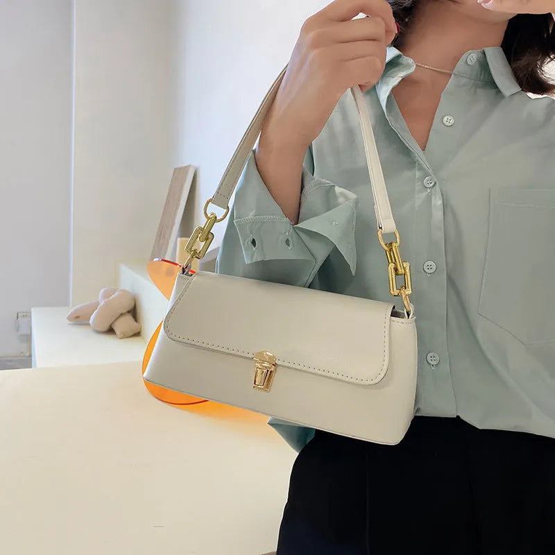 Brown French style casual underarm bag with a single shoulder chain, showing sandwich pocket and sewing thread detail.