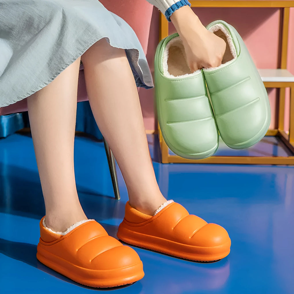 A pair of waterproof EVA couple slippers in green with a plush lining and non-slip sole.