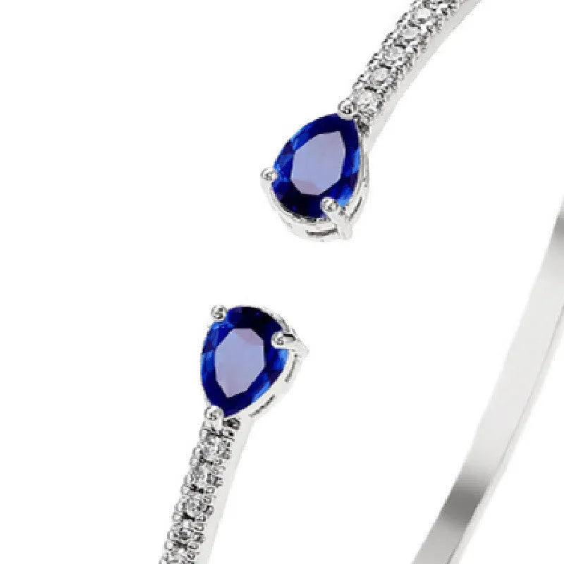 Multi-zircon copper bracelet with zircon inlaid detailing available in white or blue colour