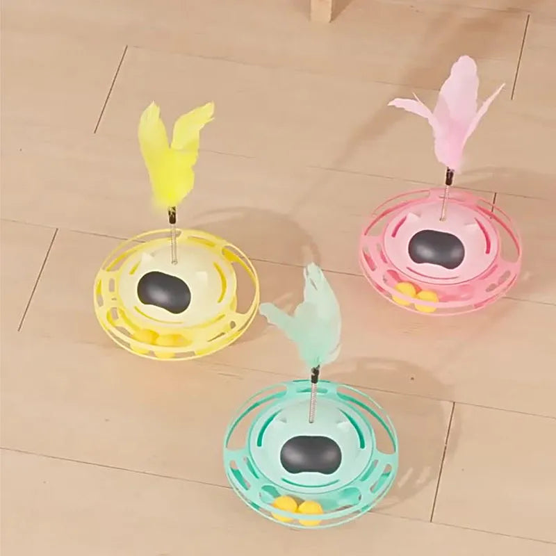 Pink cat tumbler turntable toy with interactive play stick on a flat surface.