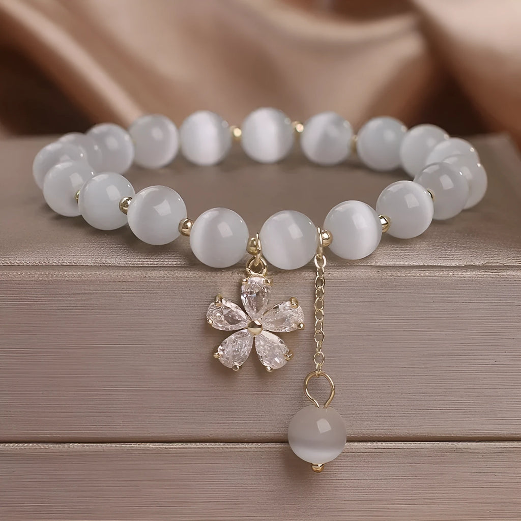 White cat's eye stone bracelet with flower tassel detail and morganite safety buckle pendant