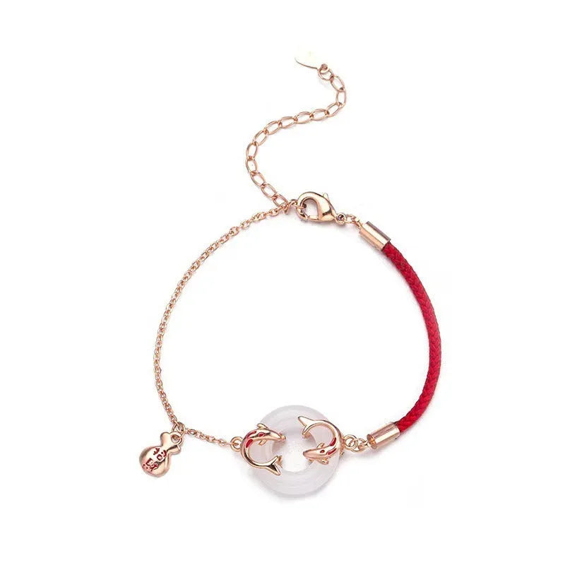 Festive koi bracelet with fishtail design and peace buckle closure on red rope