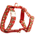 Red snowflake plaid fabric pet collar and leash set with matching dog vest and decorative bow.