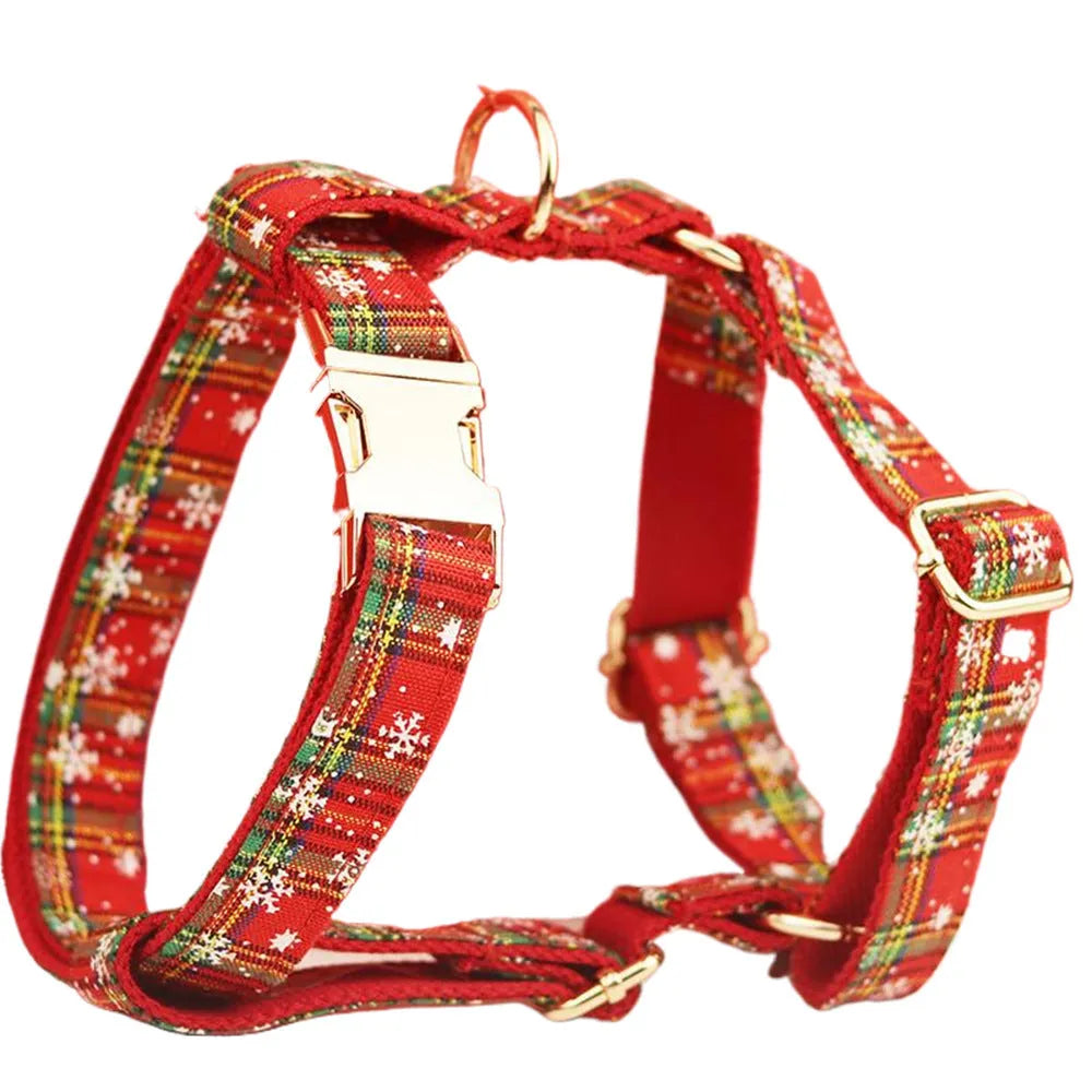 Red snowflake plaid fabric pet collar and leash set with matching dog vest and decorative bow.