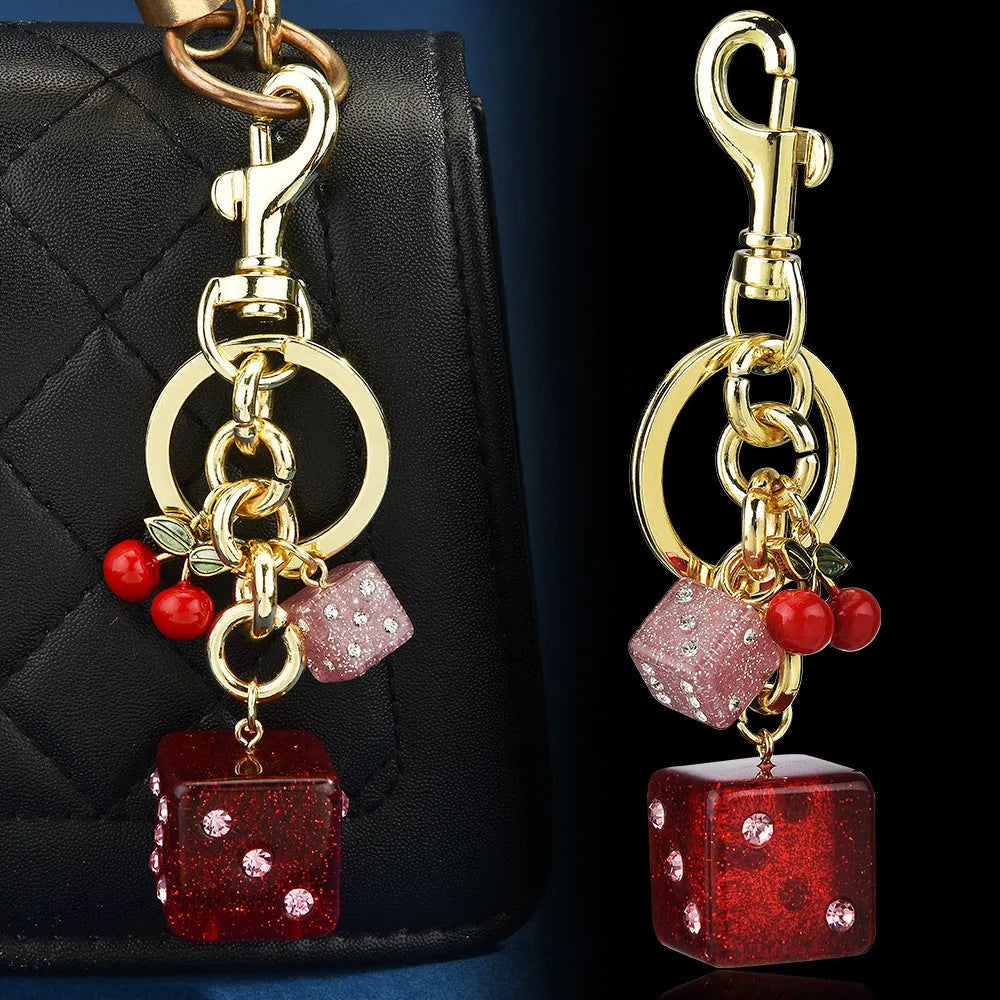 Square metal keychain pendant featuring a vintage cherry red and white two-tone dice pattern.