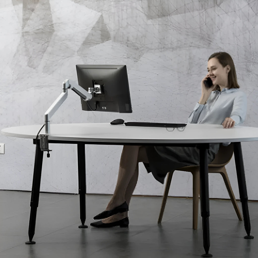 Silver aluminium alloy computer stand with hover bracket design supporting a laptop