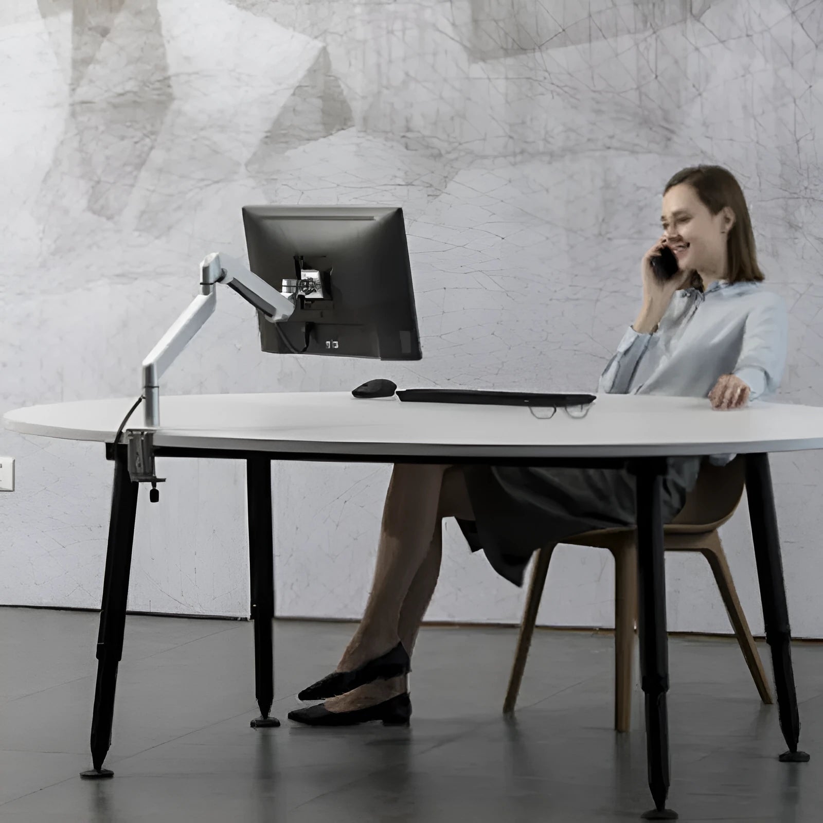 Silver aluminium alloy computer stand with hover bracket design supporting a laptop
