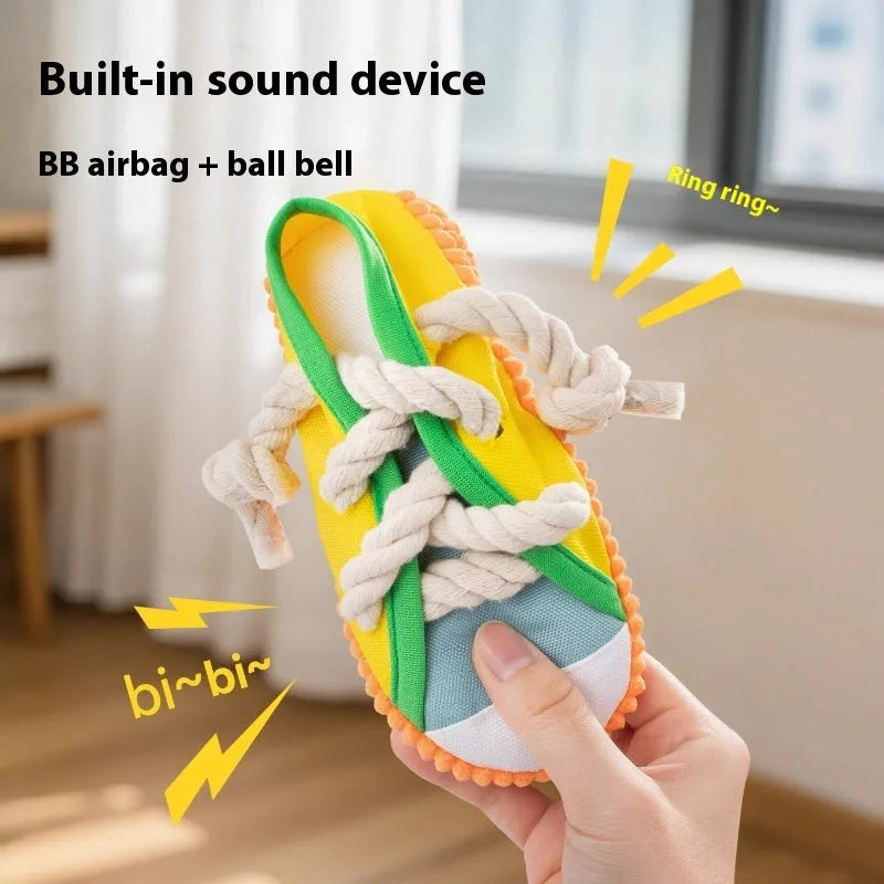 Yellow plastic dog slipper chew toy with a self-hi sound feature for biting.