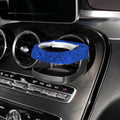 White rhinestone-encrusted car cup holder clipped onto a vehicle air vent.