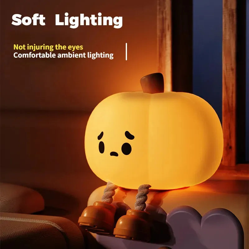 Soft orange silicone pumpkin-shaped night light with a warm glowing LED centre