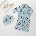 Boys' blue penguin print swim set with long sleeve swimsuit and matching swimming cap