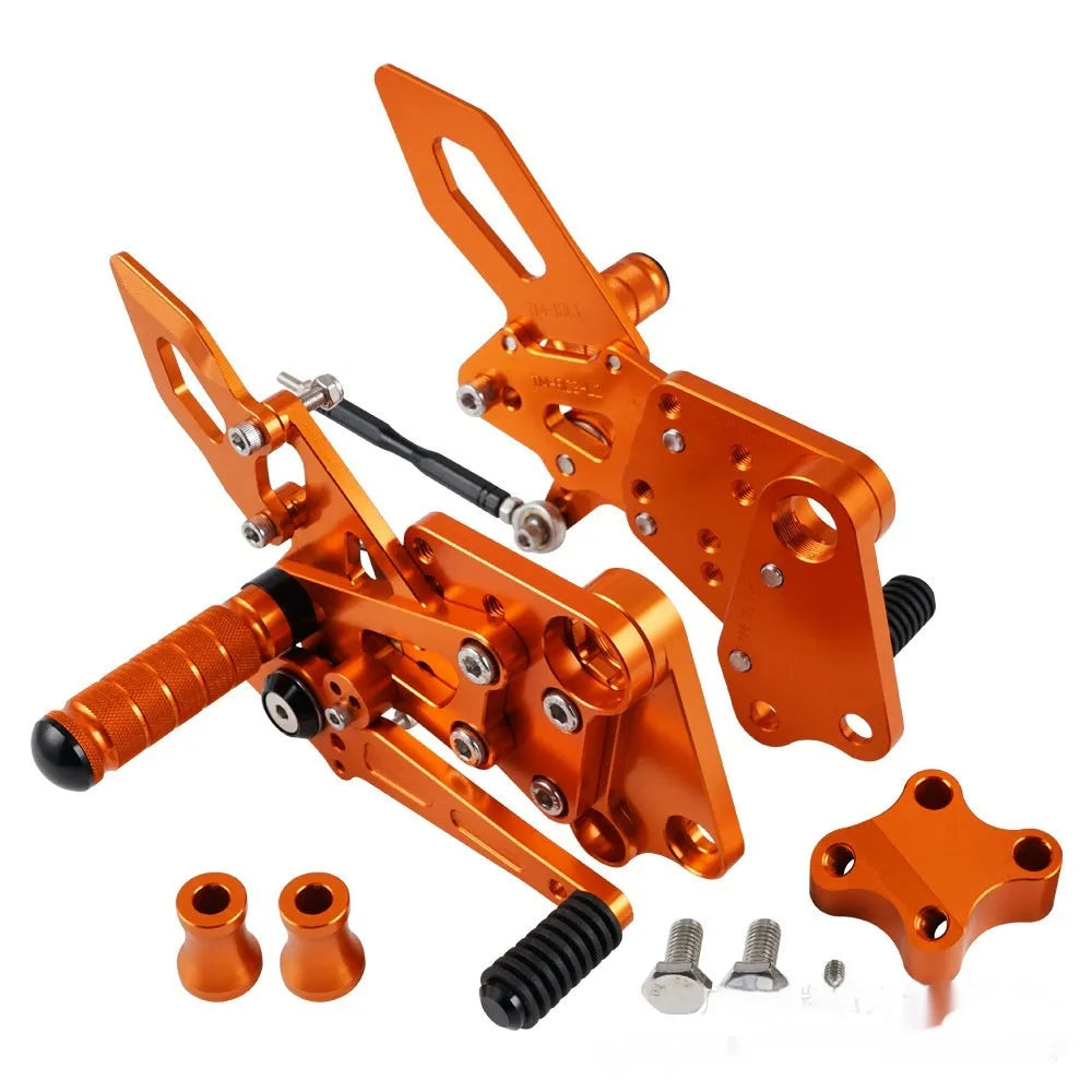 Black and orange KTM Duke motorcycle pedal support bracket assembly