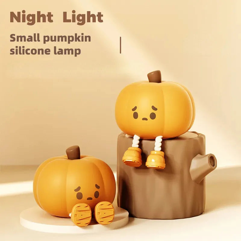 Soft orange silicone pumpkin-shaped night light with a warm glowing LED centre