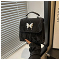 Women's preppy style hand-carry backpack in PU leather with bow detailing and mobile phone compartment