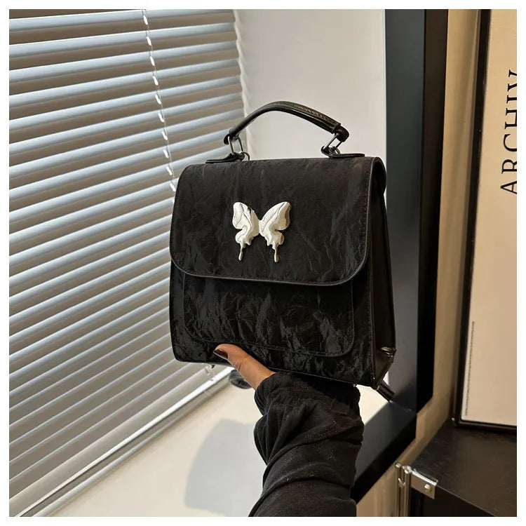 Women's preppy style hand-carry backpack in PU leather with bow detailing and mobile phone compartment