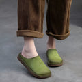 Genuine leather retro wrap-around lazy slippers in brown colour with rubber sole on a neutral background