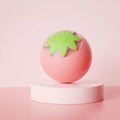 Small green automatic rolling ball toy for dogs and cats on a wooden floor.