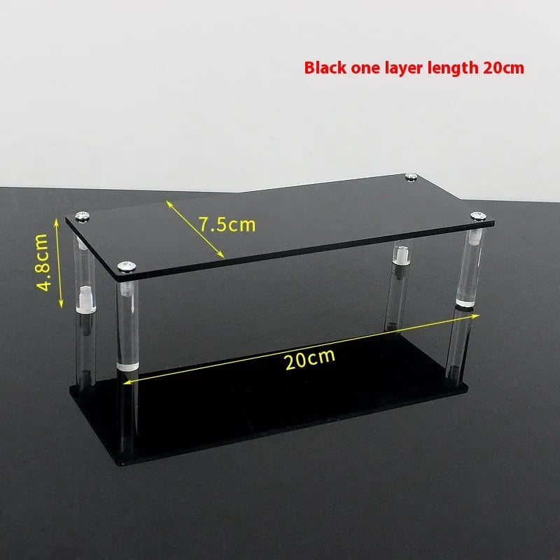 Transparent acrylic ladder display rack with three trapezoidal tiers showing blind box figurines on a desk