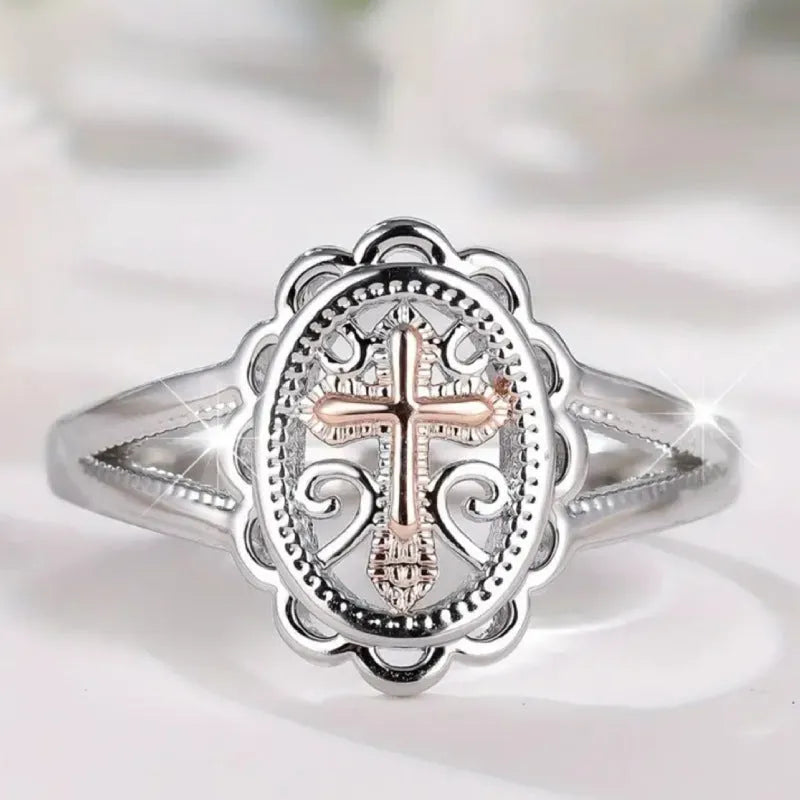Women's silver cross lace ring showing detailed patterning and electroplated finish