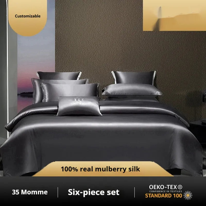 Silk four-piece quilt cover set in a solid colour, shown on a bed.