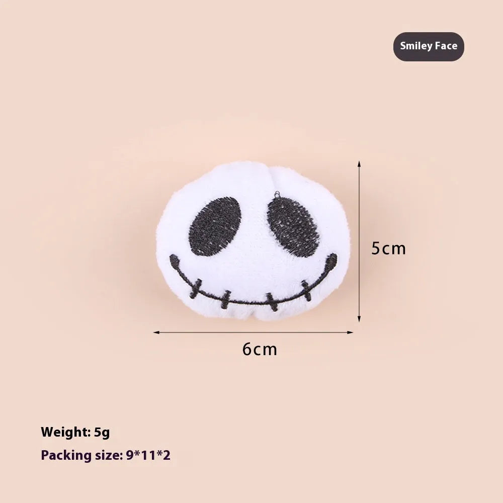 Small plush cat teaser toy with candy, eyes or skull design and feather attachment