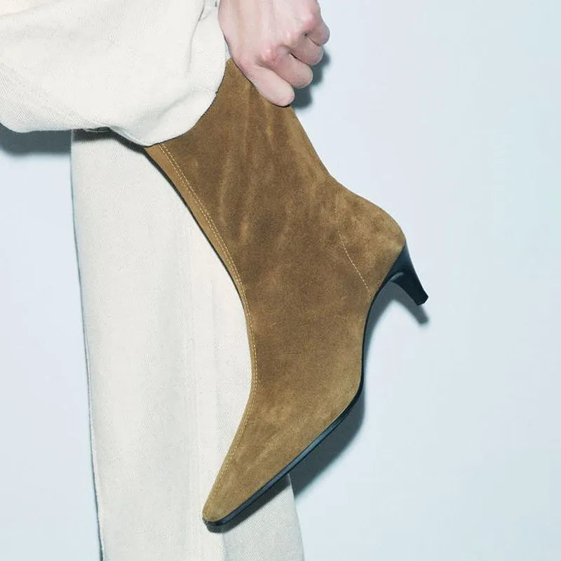 Brown square toe ankle boots with a side zip and a mid kitten heel on a plain background.