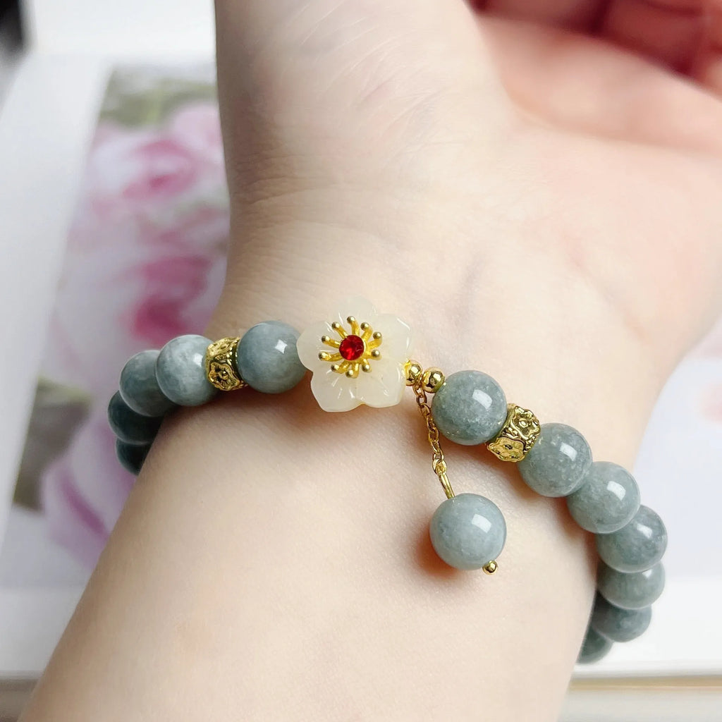 Women's retro style jade bracelet with adjustable rope closure on wrist