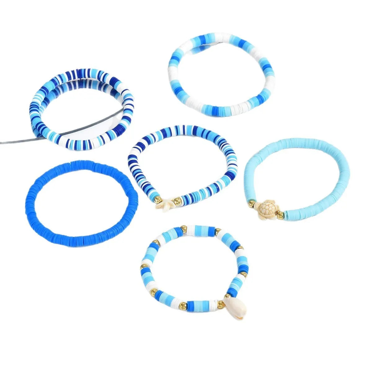 Six polymer clay handmade bracelets with Bohemian blue shells and geometric designs