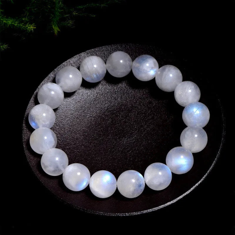 Polished moonstone bracelet with round blue beads showing natural colour variations