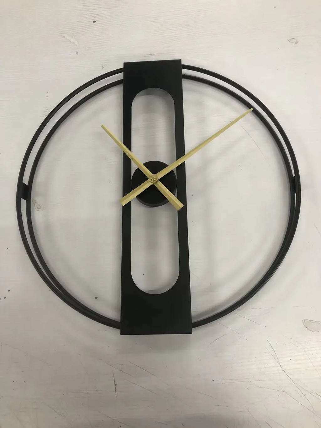 50cm round metal wall clock in black or gold finish on a wall