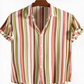 Man wearing a digitally printed short sleeve polyester shirt in a colourful summer pattern.