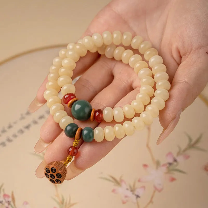 Cream Topaz Bodhi wooden bracelet with flat round beads on a wrist.
