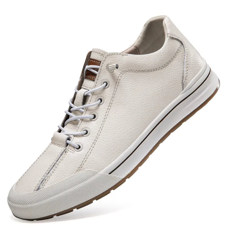 Men's white and black leather round toe flat casual trainers on a plain background.