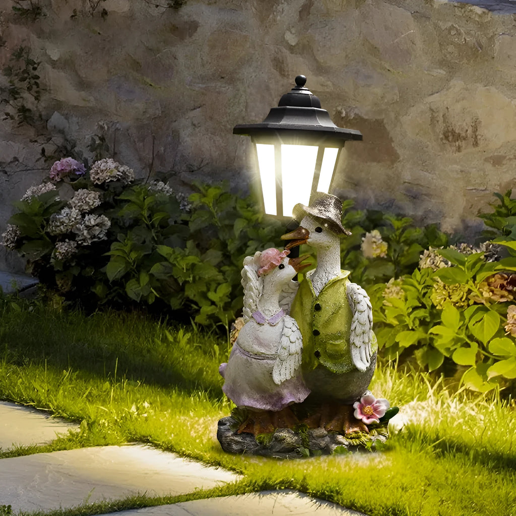 Hexagonal solar garden lamp with decorative resin animal design on grass