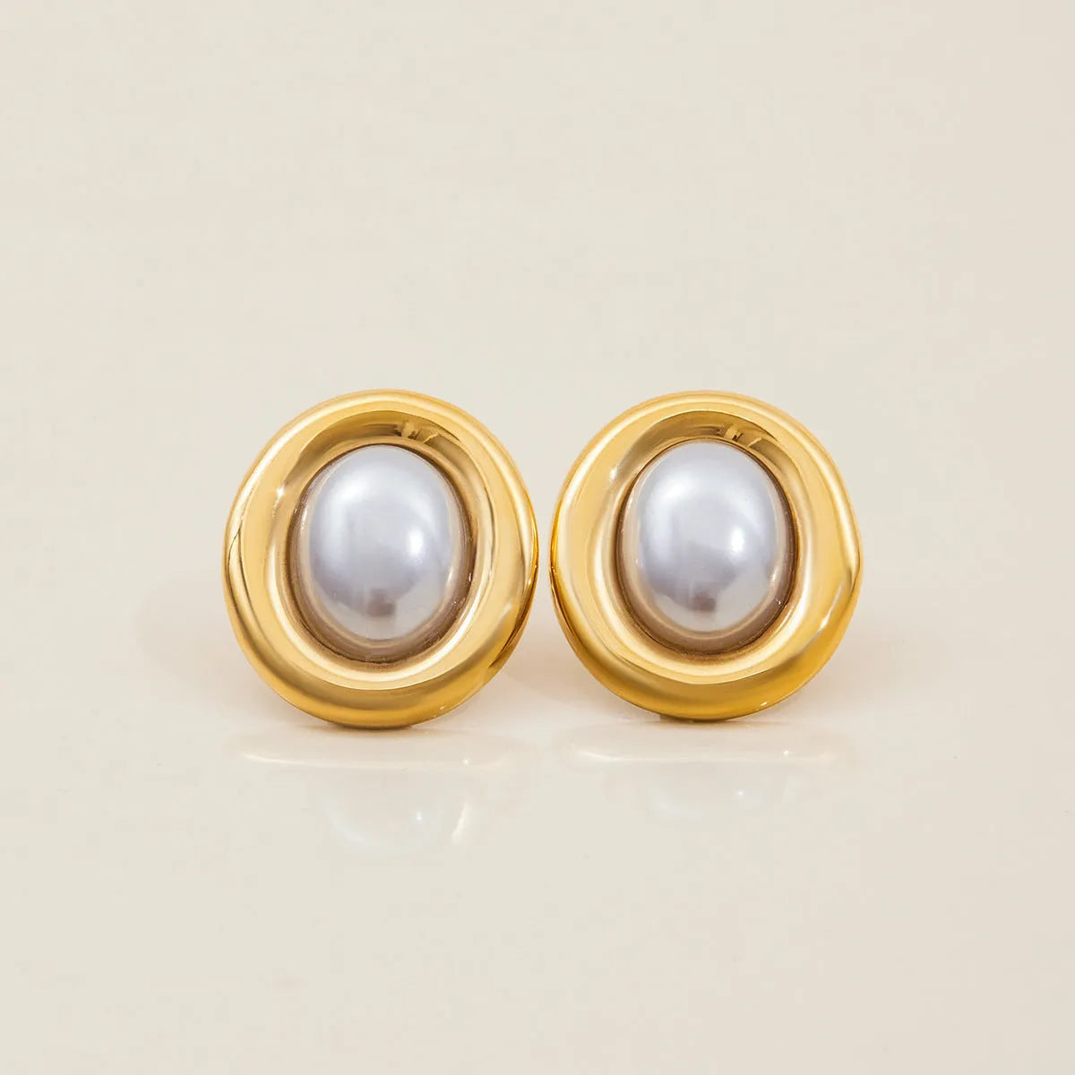 A pair of stainless steel vintage pearl stud earrings with a silver-tone electroplated finish.